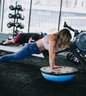 one woman doing a plank bosu ball