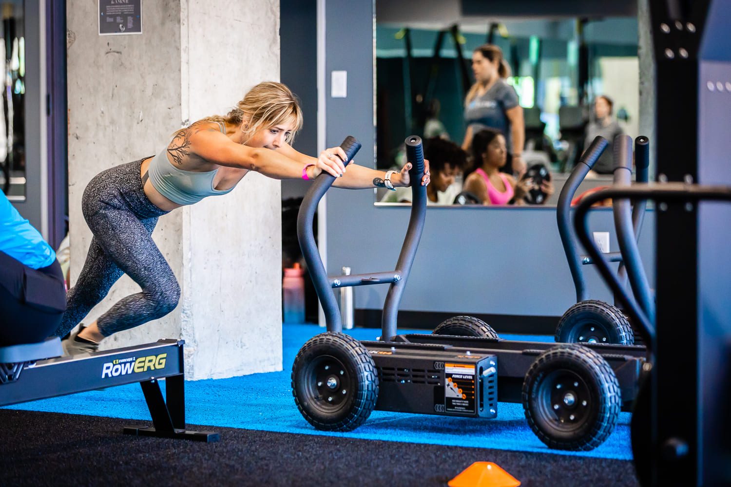 Woman training HIIT pushing tank