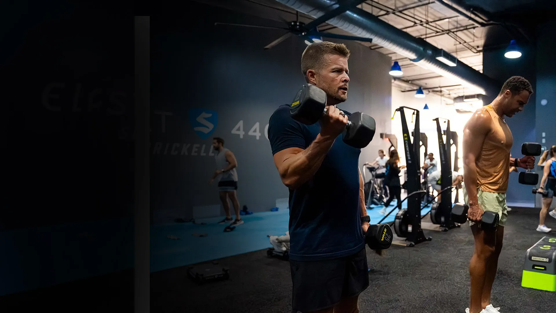 SWEAT440 franchise member training with a dumbbell at the Brickell studio