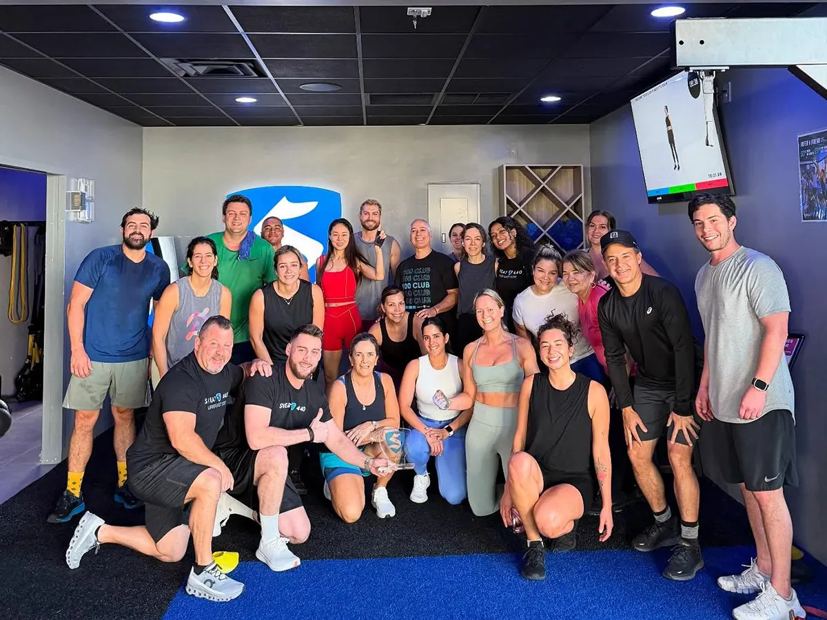 SWEAT440 members and coaches group photo at a franchise studio